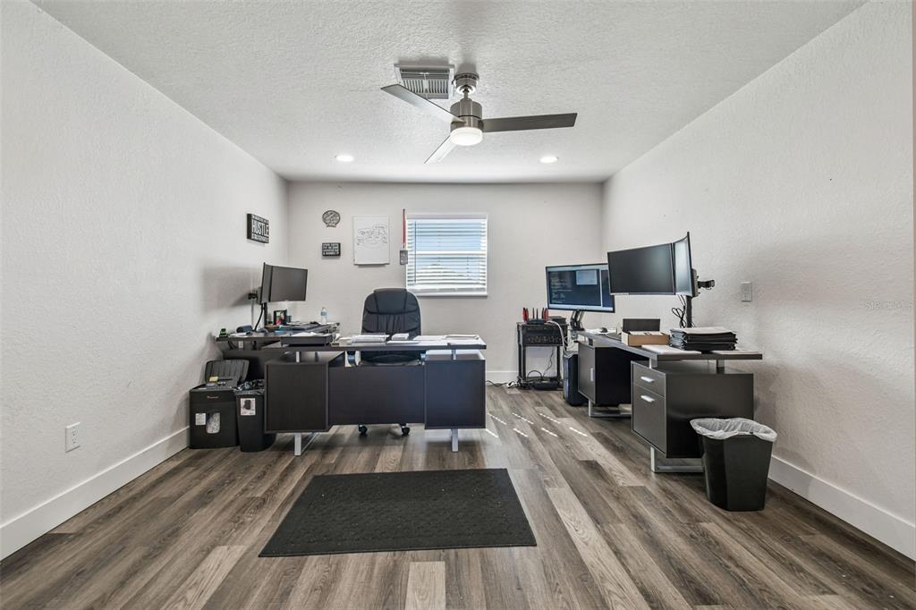 6010 Wall Street Port Richey, FL 34668 - Photo 23 of 43 a view of a workspace with furniture and wooden floor