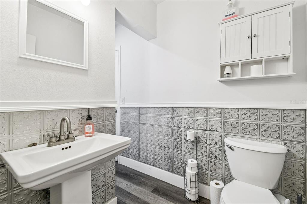 6010 Wall Street Port Richey, FL 34668 - Photo 31 of 43 a bathroom with a sink a toilet and a mirror