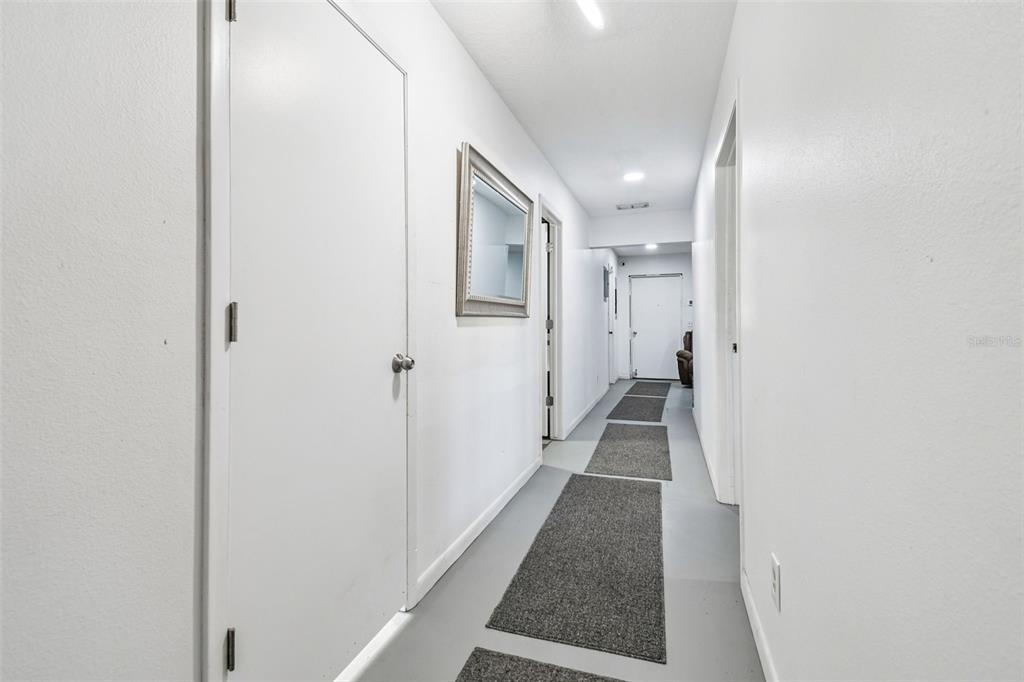 6010 Wall Street Port Richey, FL 34668 - Photo 6 of 43 a view of a hallway with wooden floor and staircase