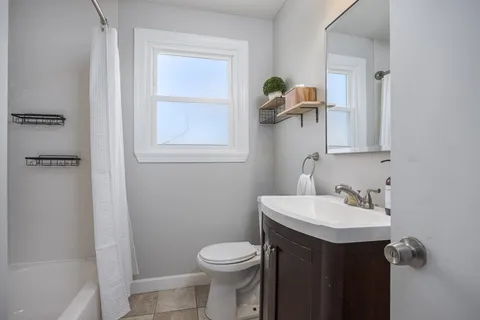 a bathroom with a sink toilet and mirror