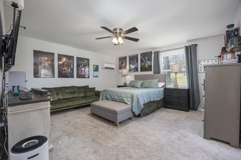 a bedroom with a bed dresser and a window