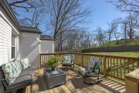 a white house covered with tall trees