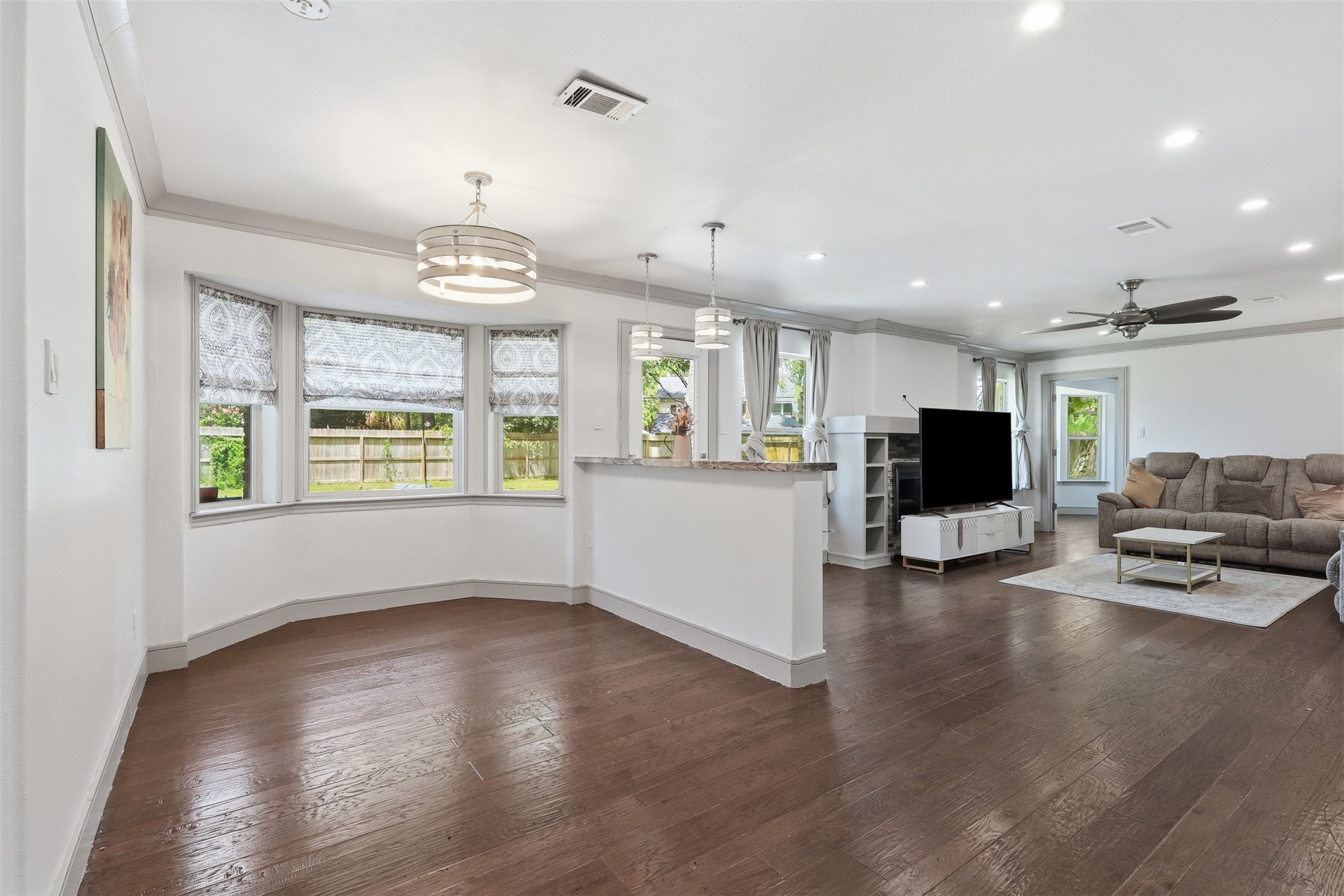 6518 Elmgrove Road Spring, TX 77389 - Photo 30 of 39 Open-concept living and breakfast area with hardwood floors, abundant natural light, and a seamless flow for everyday living.