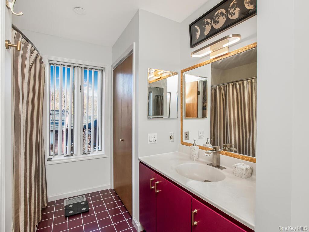 8 Davids Lane Ossining, NY 10562 - Photo 17 of 26 Bathroom with vanity, dark tile patterned flooring, and a shower with curtain