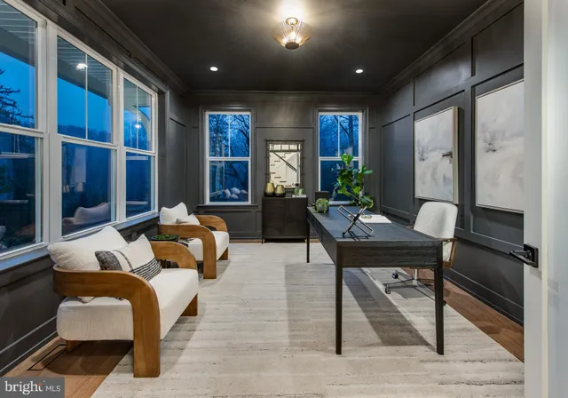 a living room with furniture fireplace and windows