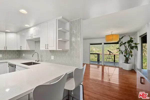 a kitchen with stainless steel appliances granite countertop a refrigerator sink and cabinets