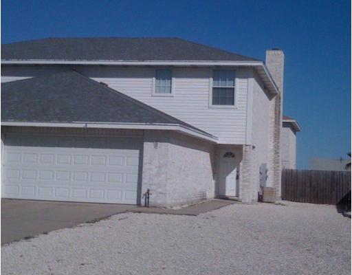 15514 Cruiser Street, Unit B Corpus Christi, TX 78418 - Photo 1 of 10 a front view of a house with garage