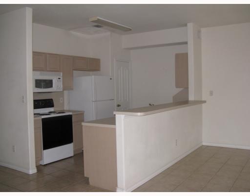 15514 Cruiser Street, Unit B Corpus Christi, TX 78418 - Photo 3 of 10 a kitchen with stainless steel appliances cabinets and a counter top space