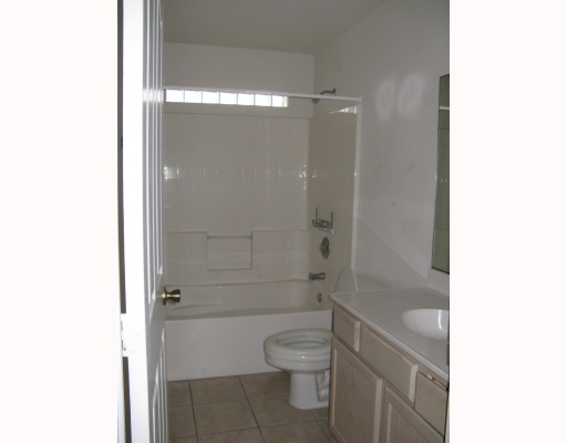15514 Cruiser Street, Unit B Corpus Christi, TX 78418 - Photo 4 of 10 a bathroom with a granite countertop toilet a sink and shower