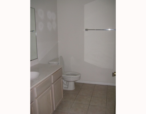 15514 Cruiser Street, Unit B Corpus Christi, TX 78418 - Photo 9 of 10 a bathroom with a granite countertop toilet and a sink