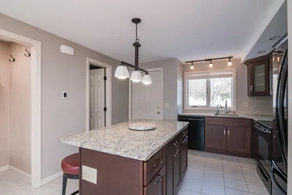 a kitchen with a kitchen island sink stove and refrigerator
