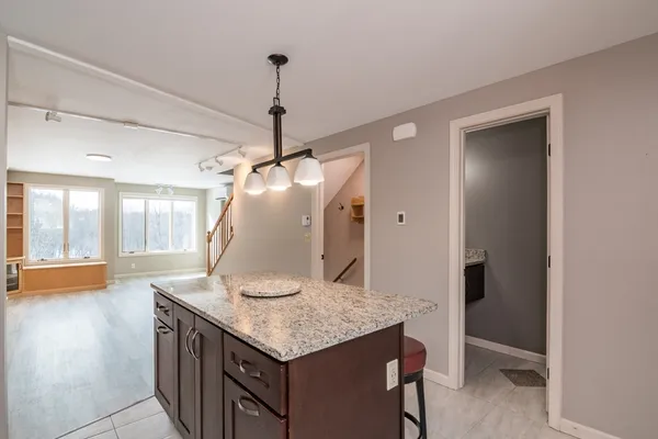 a kitchen with a table and chairs