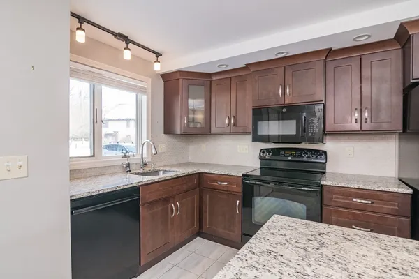 a kitchen with a sink appliances and cabinets