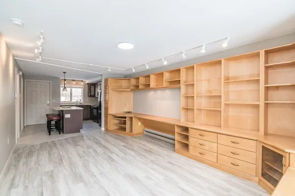a view of a room with cabinet wooden floor and windows