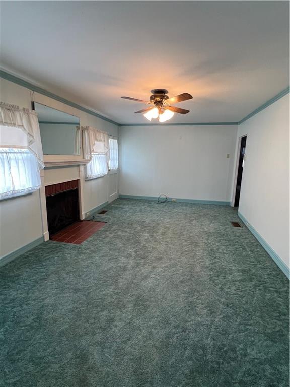 101 Filbert Road Butler, PA 16001 - Photo 13 of 37 an empty room with a fireplace and chandelier fan