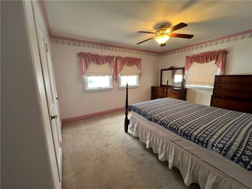101 Filbert Road Butler, PA 16001 - Photo 20 of 37 a spacious bedroom with a bed and a chandelier