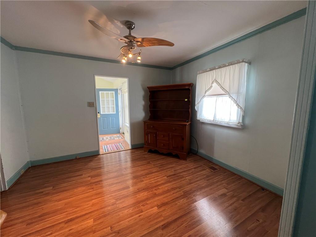 101 Filbert Road Butler, PA 16001 - Photo 5 of 37 an empty room with wooden floor fan and windows