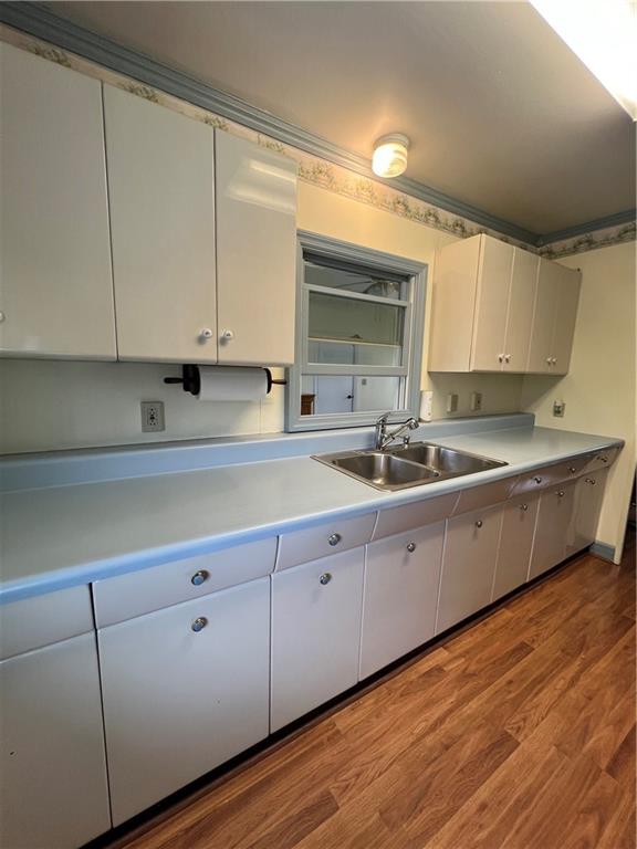 101 Filbert Road Butler, PA 16001 - Photo 9 of 37 a kitchen with cabinets a sink and dishwasher with wooden floor