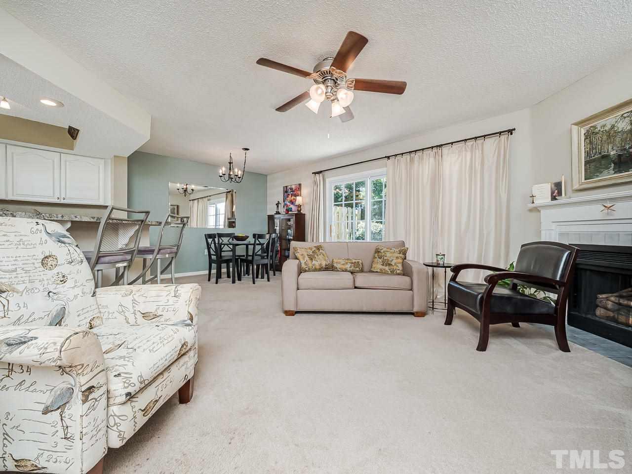 7746 Falcon Rest Circle, Unit 7746 Raleigh, NC 27615 - Photo 4 of 20 Spacious living room with wood burning fireplace.