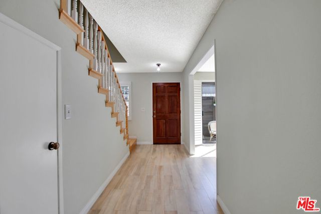 a view of an entryway with wooden floor