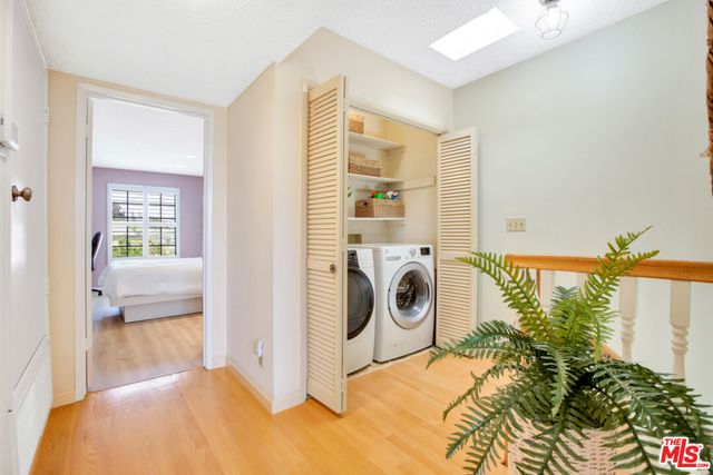 a view of a bedroom with washer and dryer