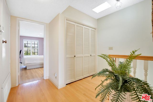 a view of a bedroom with a bed and a hallway