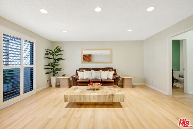 a bed room with a bed and a potted plant