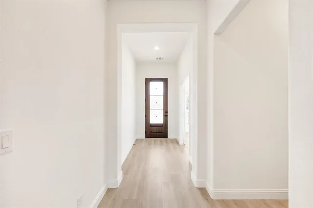 a view of a hallway with wooden floor