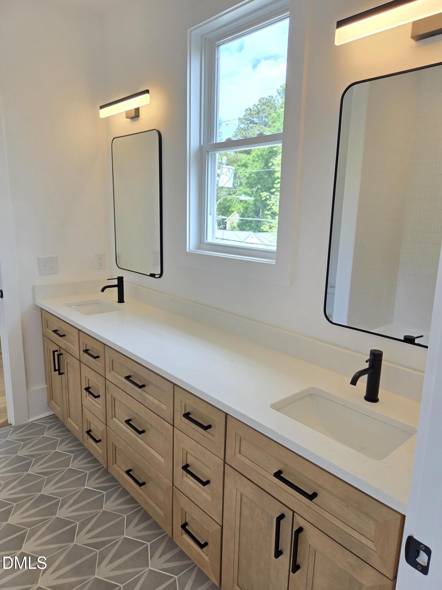 712 Van Buren Road Raleigh, NC 27604 - Photo 23 of 34 a bathroom with a double vanity sink and mirror