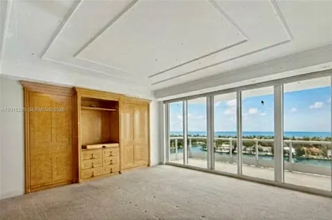 a large bedroom with a bed and large flat screen tv