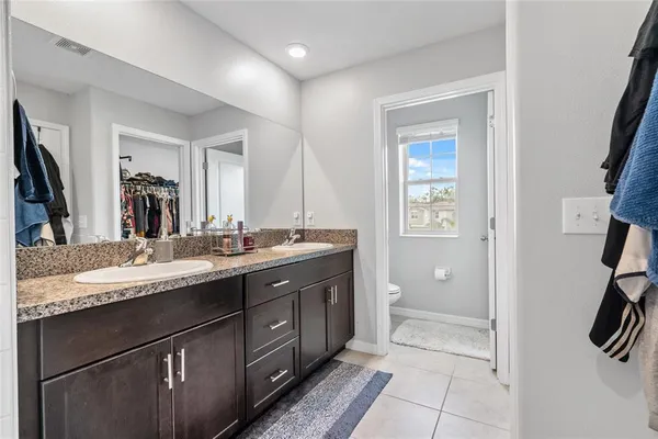 a bathroom with a granite countertop sink mirror and double