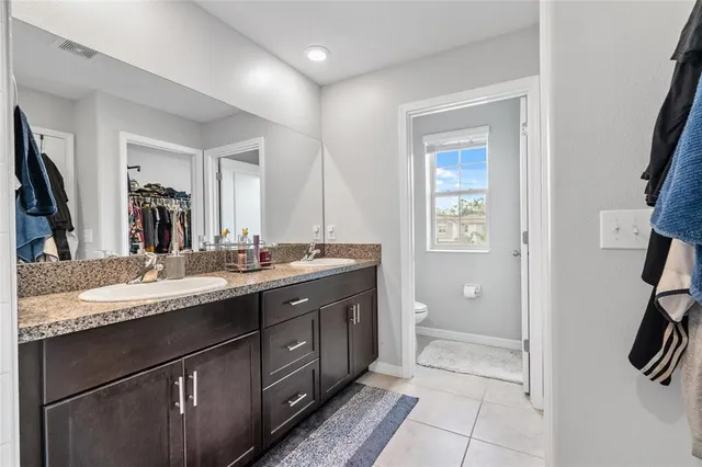 a bathroom with a granite countertop sink mirror and double