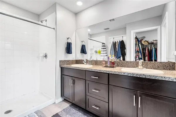 a bedroom with bed and a chandelier