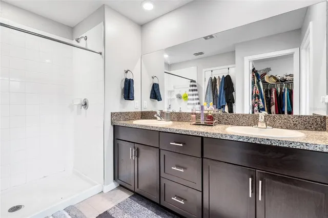 a bedroom with bed and a chandelier