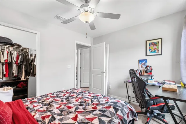 a bedroom with bed and a chandelier