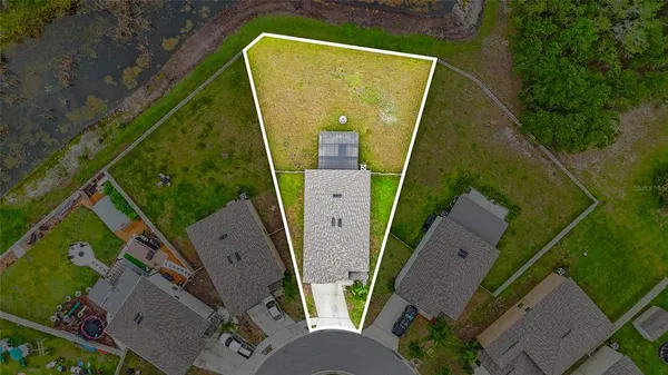 an aerial view of a house with outdoor space