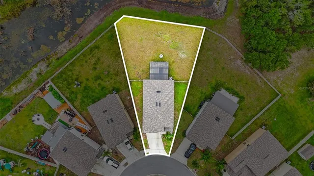 an aerial view of a house with outdoor space