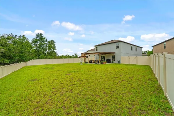 an aerial view of residential house with outdoor space and swimming pool