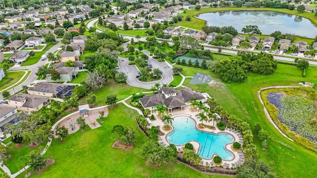 a front view of a house with a yard and outdoor seating