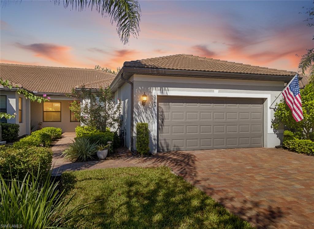 a view of a house with a small yard and plants