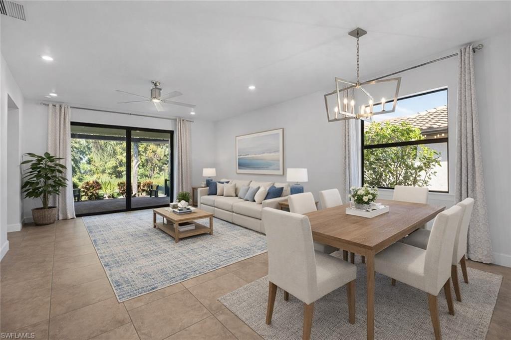 5845 Mayflower Way Ave Maria, FL 34142 - Photo 11 of 48 a living room with furniture and a large window