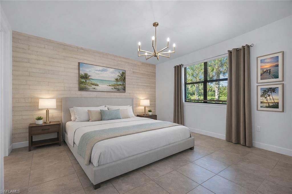 5845 Mayflower Way Ave Maria, FL 34142 - Photo 16 of 48 a bedroom with a large bed and a window