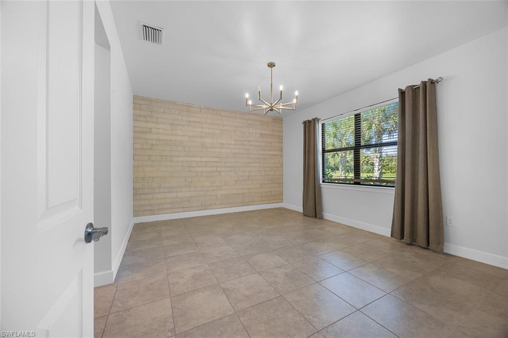 5845 Mayflower Way Ave Maria, FL 34142 - Photo 17 of 48 en empty room with windows and entryway