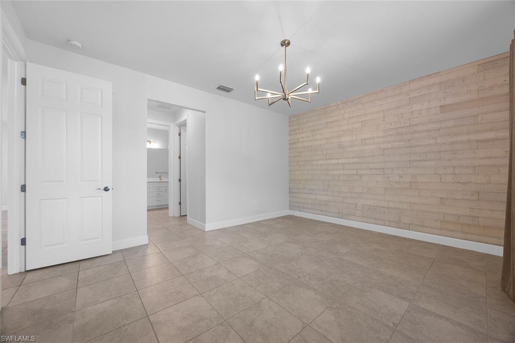 5845 Mayflower Way Ave Maria, FL 34142 - Photo 18 of 48 an empty room with kitchen view