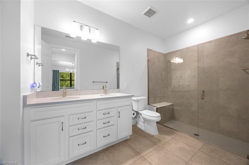 5845 Mayflower Way Ave Maria, FL 34142 - Photo 21 of 48 a bathroom with a double vanity sink mirror and toilet