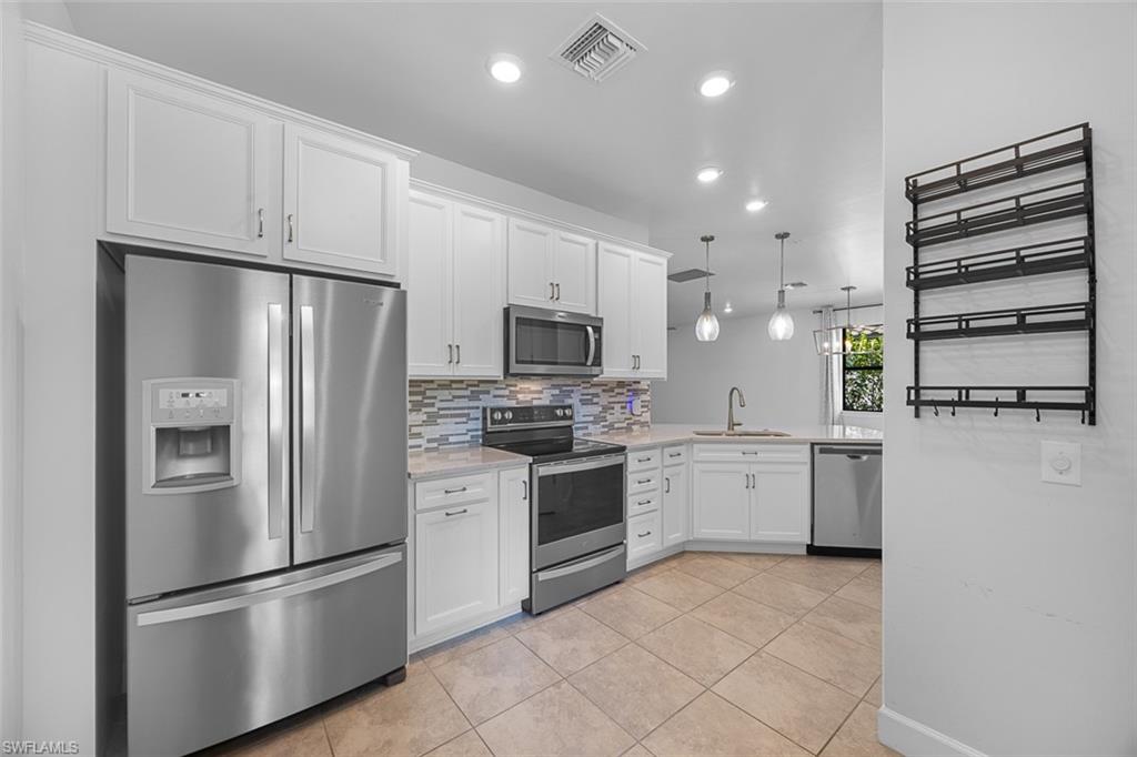 5845 Mayflower Way Ave Maria, FL 34142 - Photo 3 of 48 a kitchen with a refrigerator stove and microwave