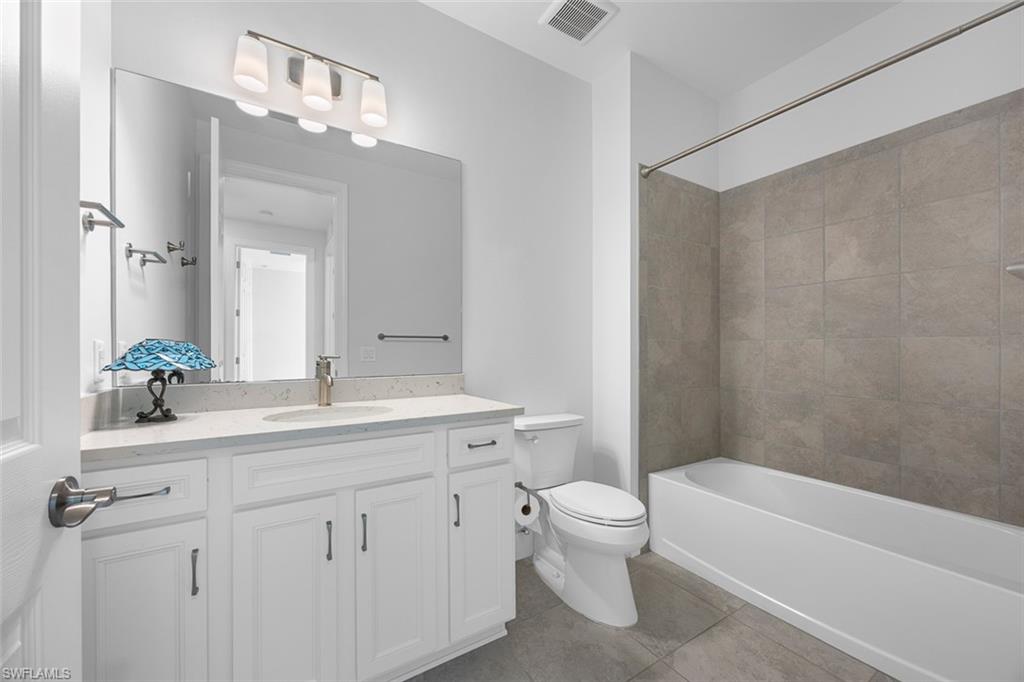 5845 Mayflower Way Ave Maria, FL 34142 - Photo 35 of 48 a bathroom with a granite countertop sink a toilet and a bathtub