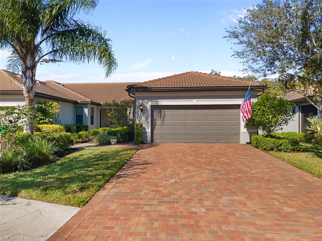 5845 Mayflower Way Ave Maria, FL 34142 - Photo 37 of 48 a front view of a house with a garden
