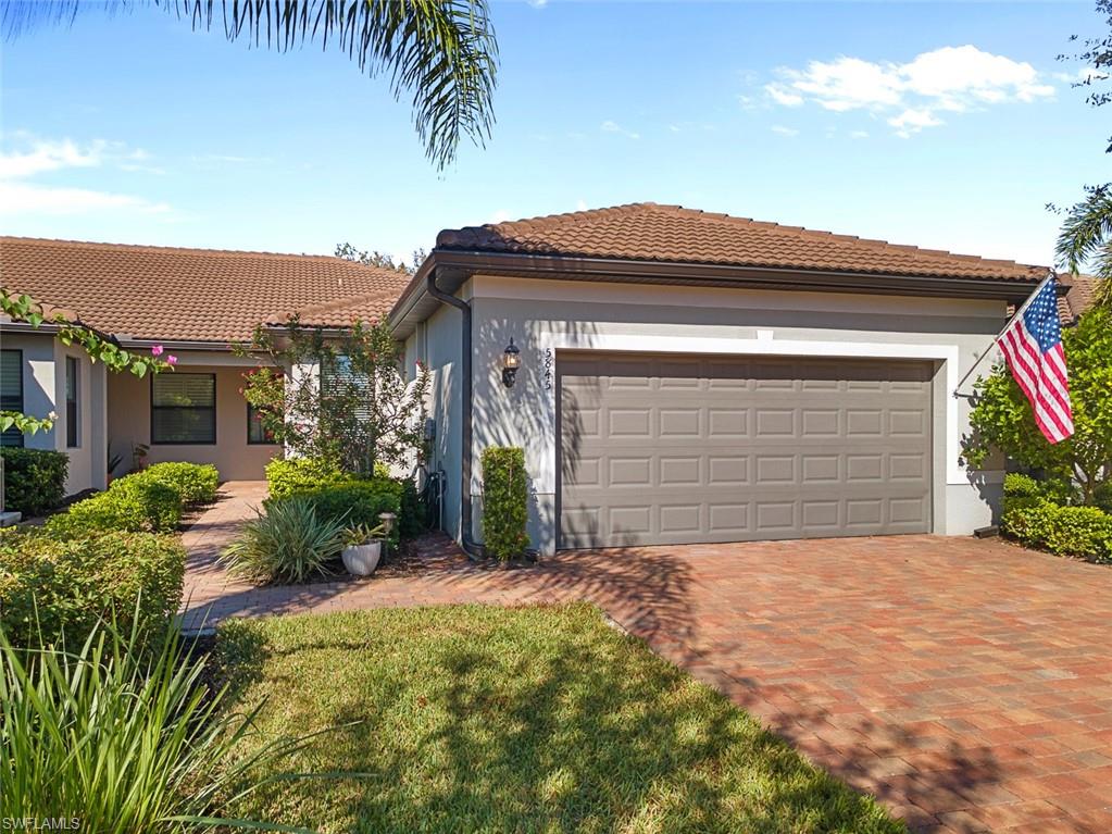 5845 Mayflower Way Ave Maria, FL 34142 - Photo 39 of 48 a view of house with garage and plants