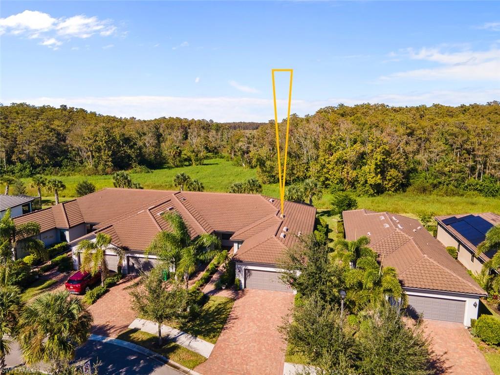 5845 Mayflower Way Ave Maria, FL 34142 - Photo 40 of 48 an aerial view of residential houses with outdoor space and trees